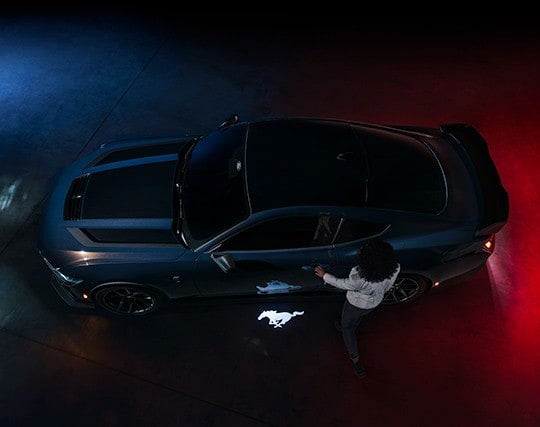 2024 Ford Mustang® Dark Horse™ model with a driver approaching the vehicle | Lundgren Ford in Eveleth MN
