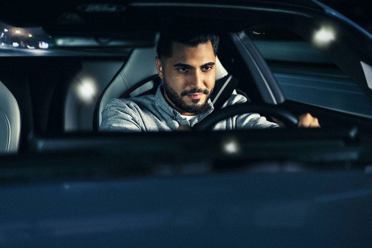 Person sitting in the driver’s seat of a parked 2024 Ford Mustang® coupe | Lundgren Ford in Eveleth MN
