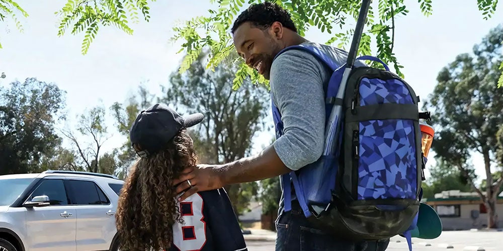 Father taking daughter home from baseball game